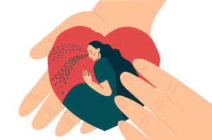 Close up of a hand holding a heart with a crying woman inside
